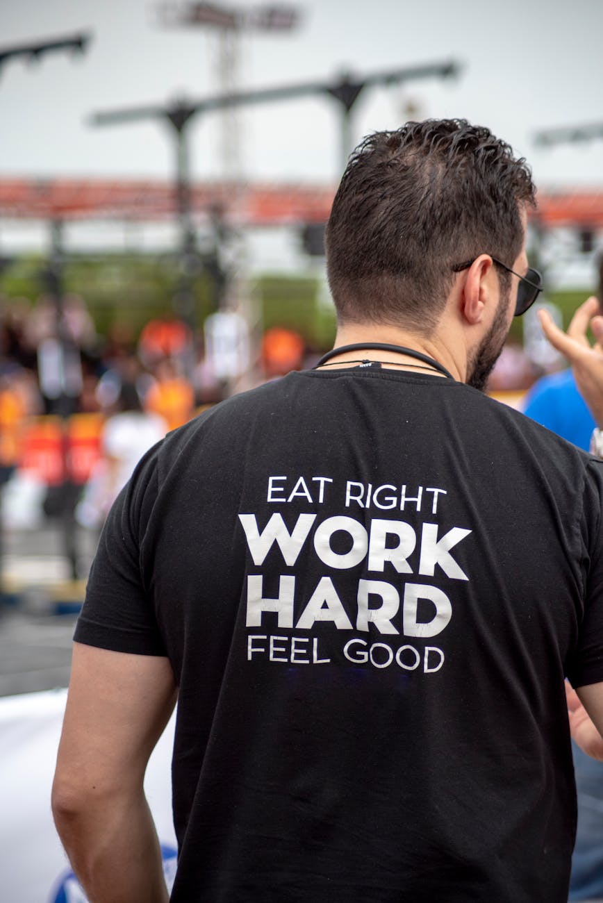 person wearing eat right work hard feel good printed shirt