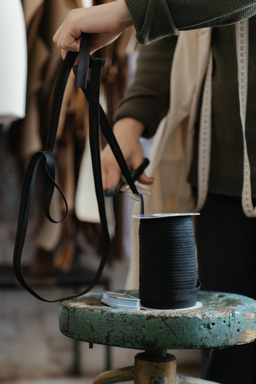 black leather sling bag on blue and white ceramic mug