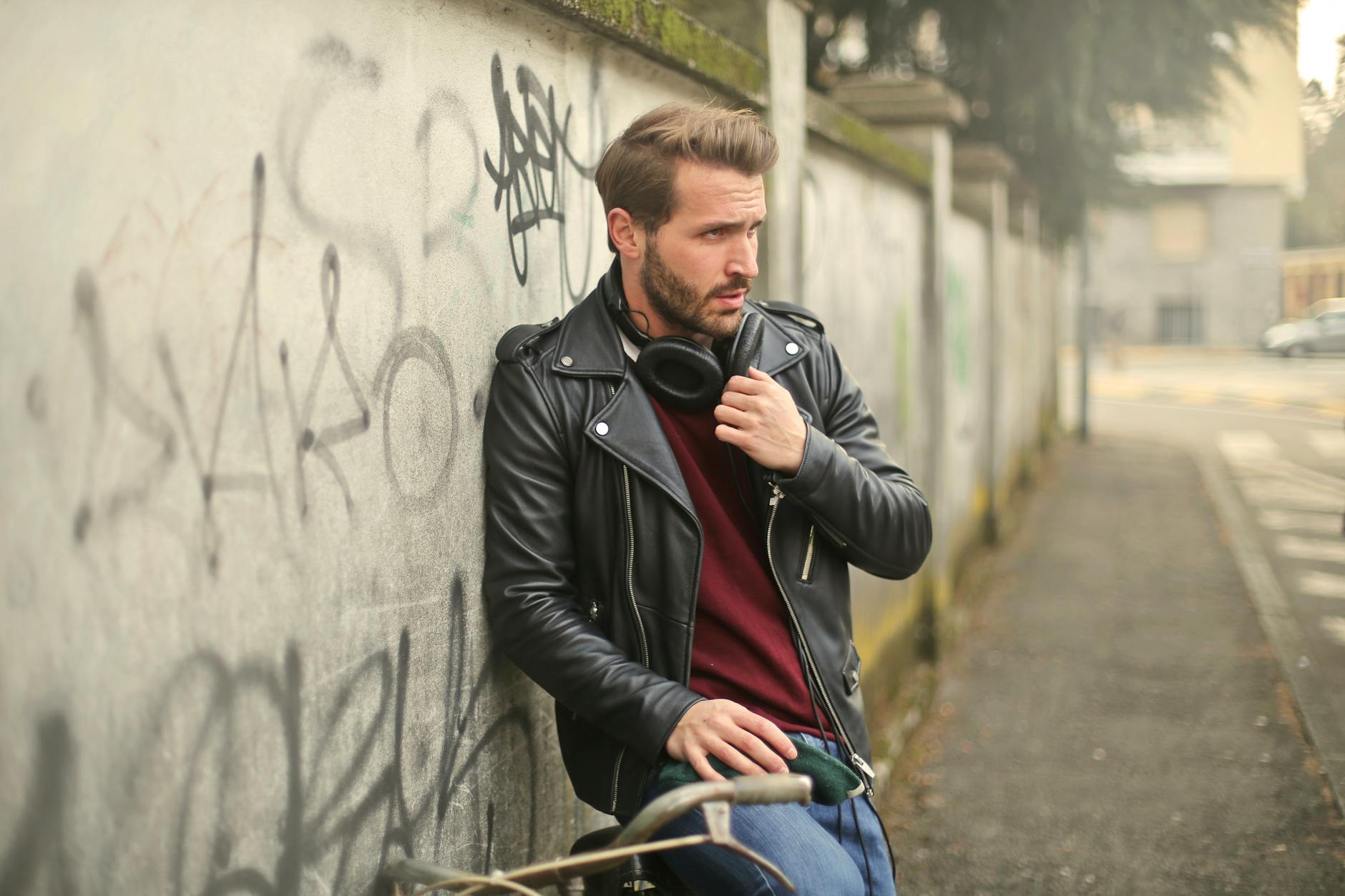 man wearing black full zip biker jacket